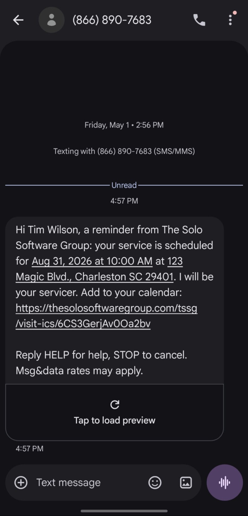 A service visit reminder text message on a phone